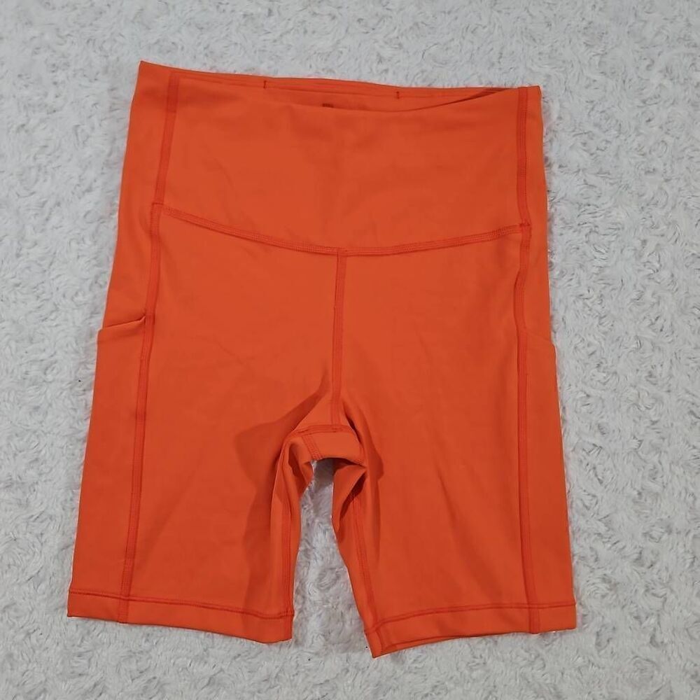Athleta Ultimate Stash Pocket 7" Short women's XS bike compression Orange Haze